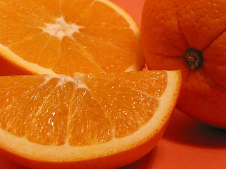 Fresh oranges on orange background, closeup