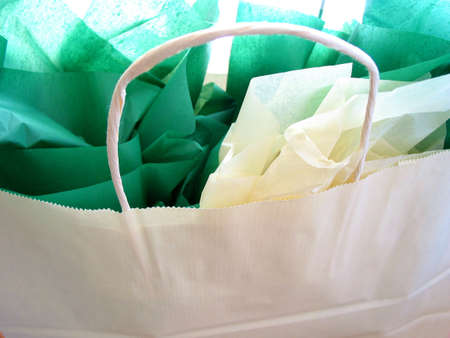 White shopping bag with green tissue closeup