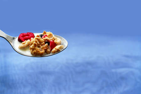 Spoon of cereal on blue backgroundの写真素材