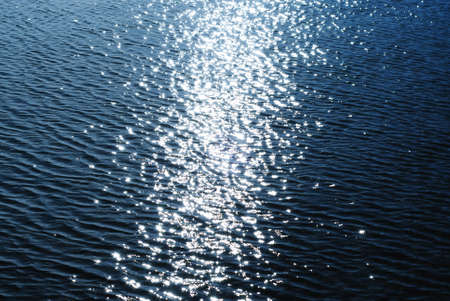 Sparkling water background: andamp,quot,star effectandamp,quot, from sun reflections.の写真素材