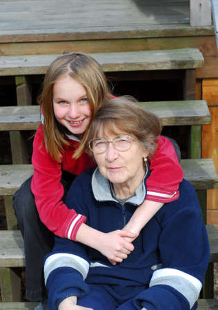 Granddaughter and grandmother on the deck stairs
