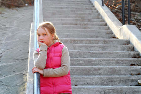 Young girl standing on concrete stairwayの写真素材