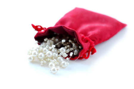 Pearls in red pouch on white backgroundの写真素材