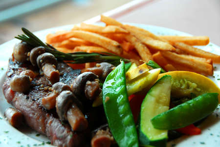 Mushroom steak with vegetables and friesの写真素材