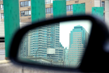 Reflection of a city in a car mirror on rainy dayの写真素材