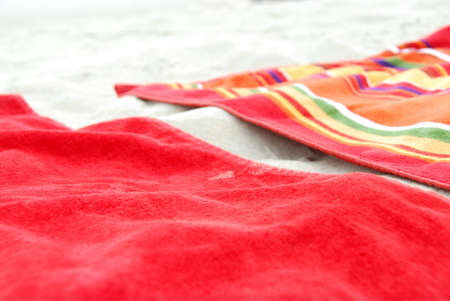 Two colorful beach towels on sandy beachの写真素材