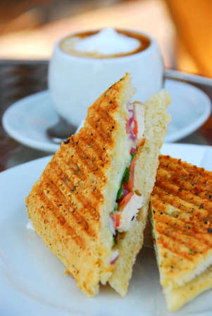 Grilled chicken sandwich and a cup of coffeeの写真素材