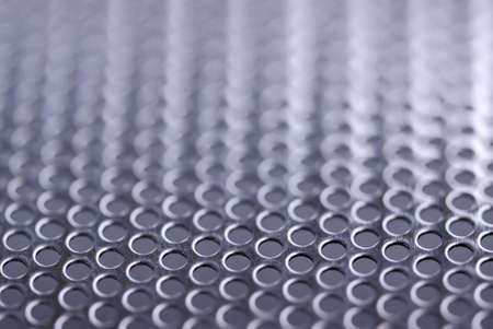 Abstract background of perforated metal with very shallow dofの写真素材