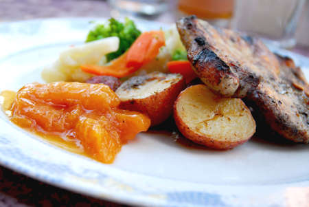 Pork chip dinner with fruit chutneyの写真素材