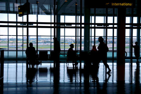 People waiting at the airport terminalの写真素材