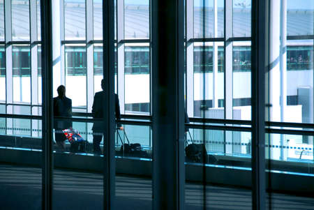 People walking at the airport with luggageの写真素材