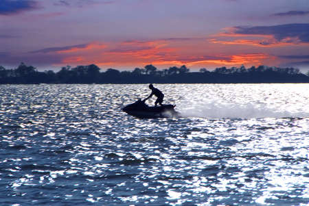 Man on jet ski at sunsetの写真素材