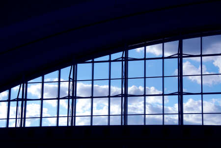 Big window at the moder airport with blue sky and cloudsの写真素材