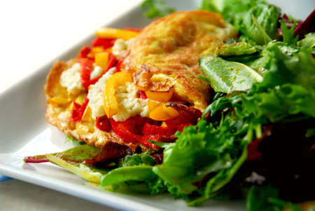 Freshly made omelette served with green saladの写真素材