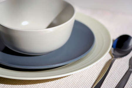 Dinner place setting  - plates bowl and cutleryの写真素材
