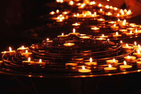 Rows of burning candles inside a cathedralのeditorial素材