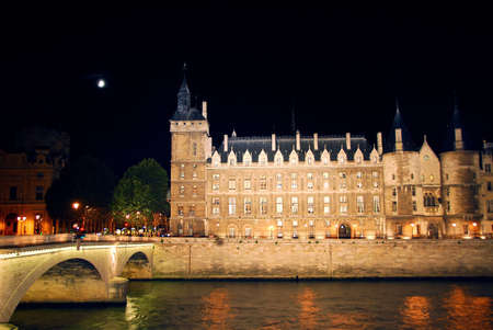 Bridges over Seine and Conciege in nighttime Paris Franceの写真素材
