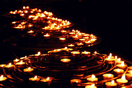 Rows of burning candles in a cathedralのeditorial素材