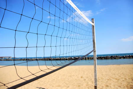 Beach volleyball net in perspective on a sandy beachの写真素材