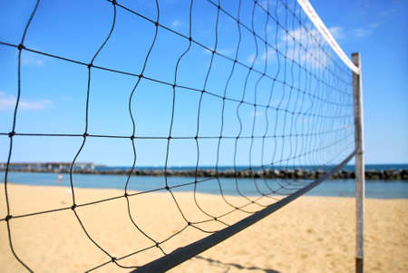 Beach volleyball net in perspective on a sandy beachの写真素材