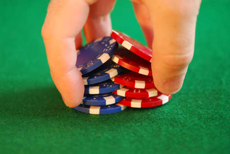 Close up on man's hand doing a pocker chip trick shuffle