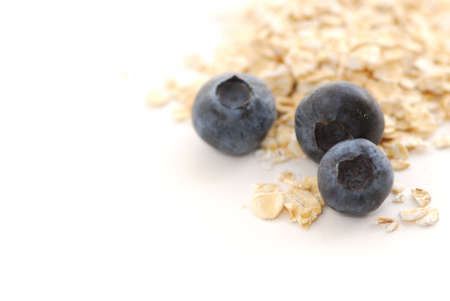 Blueberries and oats macro on white backgroundの写真素材