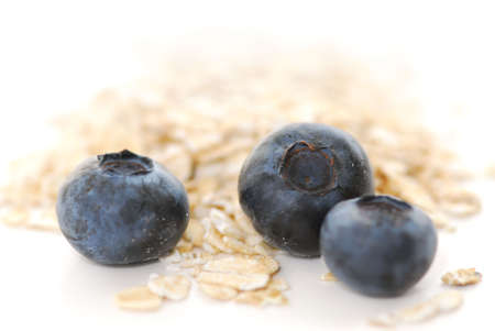 Blueberries and oats macro on white backgroundの写真素材