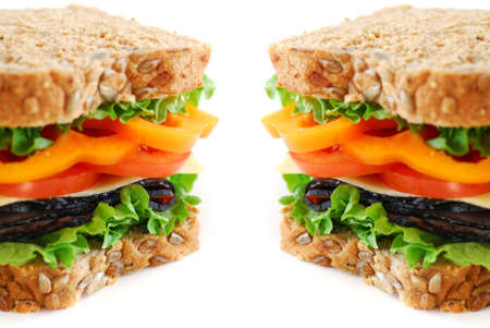 Big healthy sandwich with vegetables and meat close up on white backgroundの写真素材