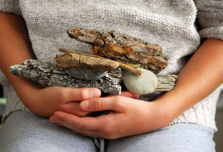 Child hands holding beach treasures collected on sea shoreの写真素材