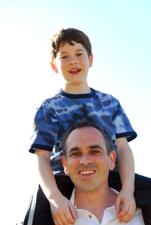 Portrait of father and son playing outdoors