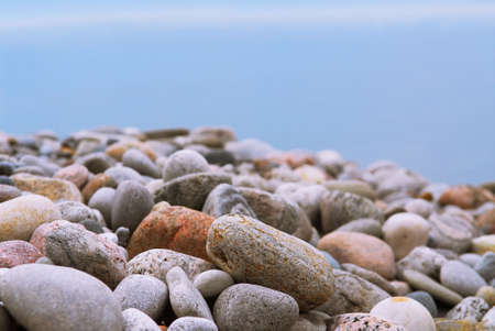 Background of colofrul beach pebbles of different shape and water