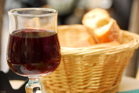 Glass of young red wine and fresh breadの写真素材