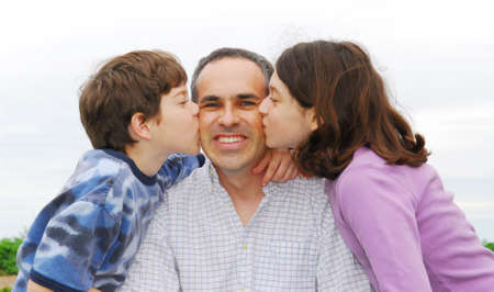 Grateful children giving their father a kissの写真素材