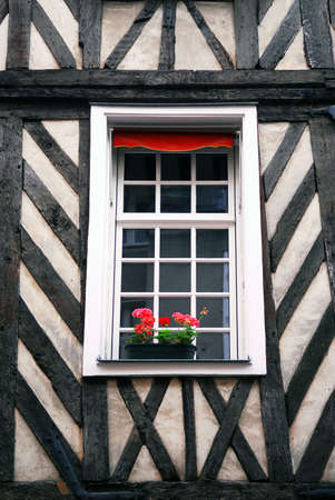 Window in a medieval half-timbered house in Rennes, France.の写真素材