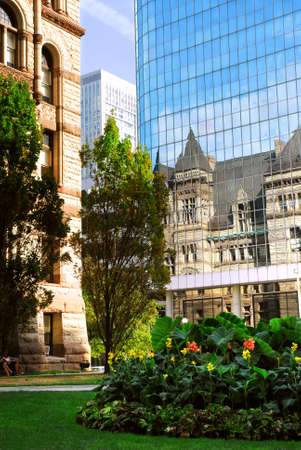 Reflection of old Toronto city hall building in a glass wall of a modern highrise buildingの写真素材