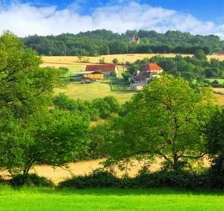 Scenic view on summer agricultural landscape in rural France with a farmhouse and barnの写真素材