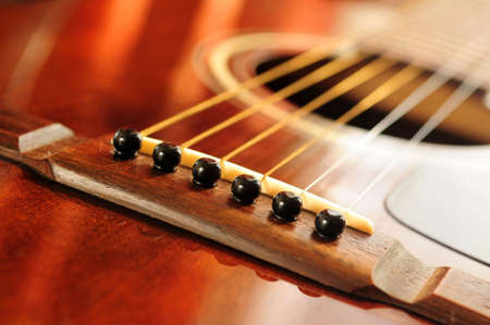 Acoustic guitar bridge and strings close upの写真素材