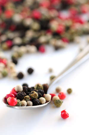 Mixed assorted peppercorns on white background macroの写真素材