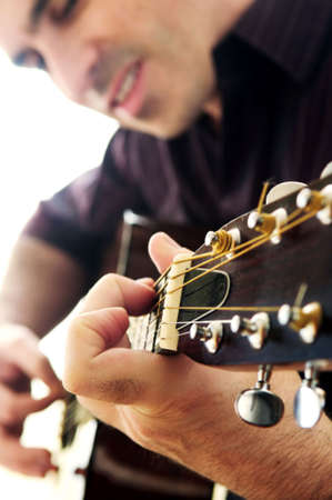 Man playing a musical instrument accoustic guitar