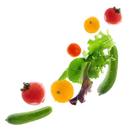 Assorted fresh vegetables flying isolated on white backgroundの写真素材