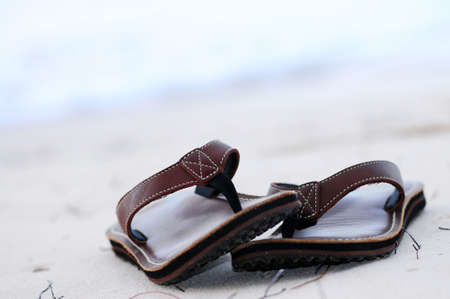 Flipflops on a sandy ocean beach - summer vacation conceptの写真素材