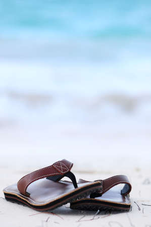 Flipflops on a sandy ocean beach - summer vacation conceptの写真素材