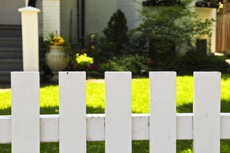 White fence around front yard of residential の写真素材