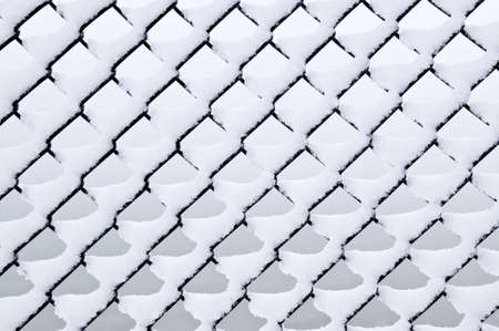 Pattern of chain link fence under fresh snowの写真素材