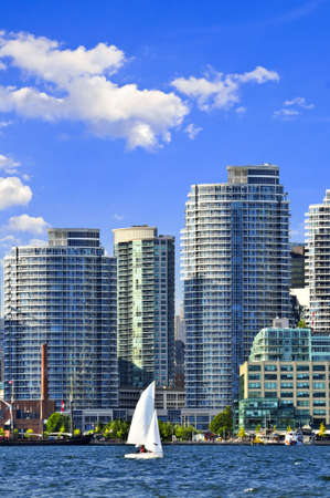 Sailboat sailing in Toronto harbour with scenic waterfront viewの写真素材