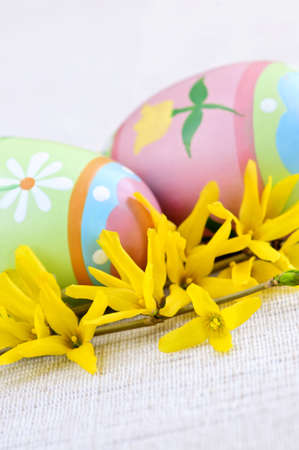 Easter eggs arrangement with yellow forsythia flowers