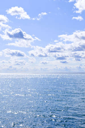 Blue ocean water and sunny sky backgroundの写真素材