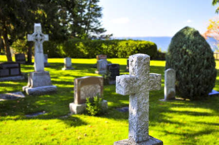Bright graveyard lawn with ancient tombstone crosses