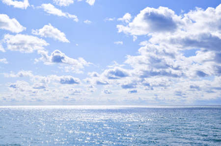 Blue ocean water and sunny sky backgroundの写真素材