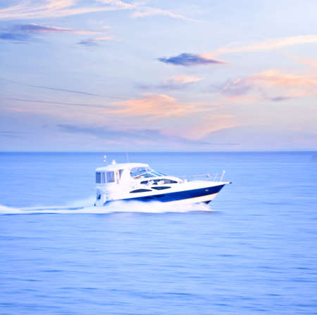 Speedboat at dusk, panning shot, in-camera motion blurの写真素材
